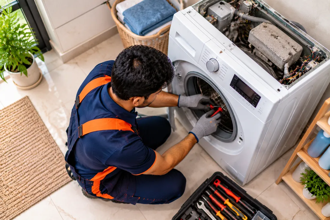 Washing Machine repair technician at work
